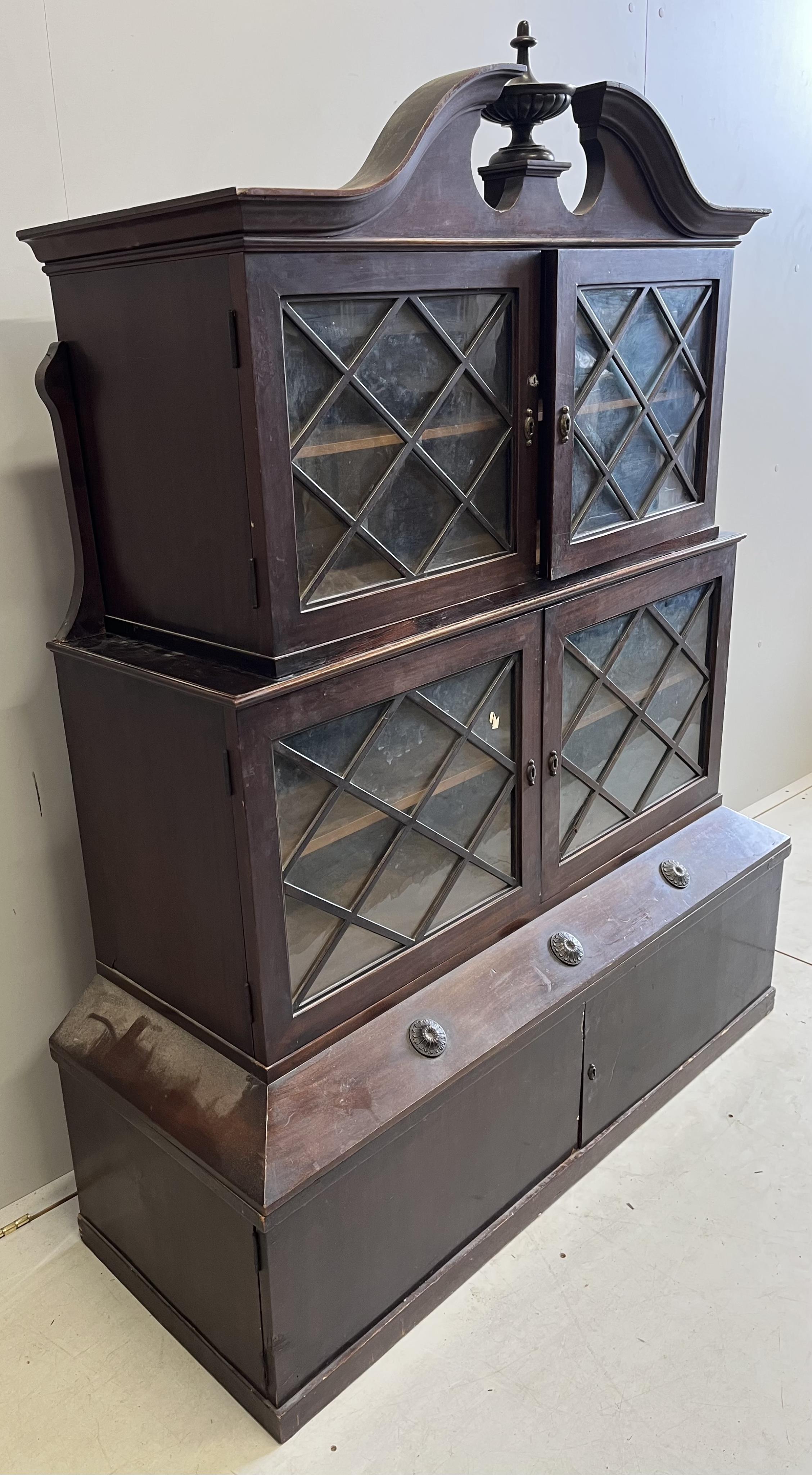 A George III style mahogany three section bookcase / cabinet, incorporating old timber, width 126cm, depth 47cm, height 160cm. Condition - fair